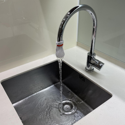 Water flowing out of tap with cloth filter.